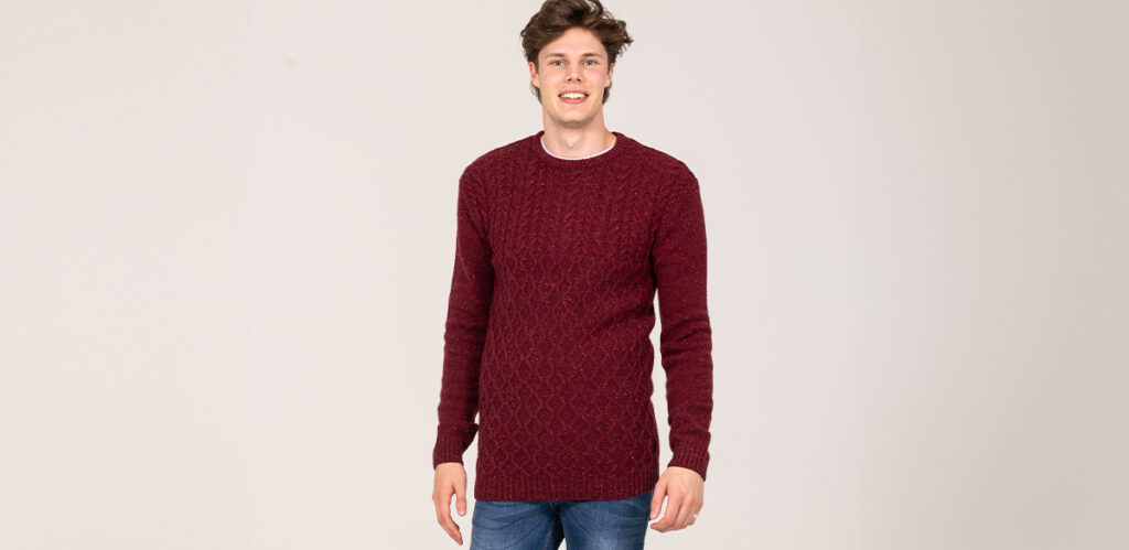 Model is 6'7"/201CM wearing a Cherry coloured size LT 2t Tall Aran Crew Neck Lambswool Jumper.